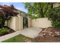 Inviting front entrance with a private courtyard, secure gate, and well-maintained landscaping at 9240 E Girard Ave # 1, Denver, CO 80231