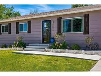 Charming single story home showcasing a well-manicured lawn and inviting entryway at 6655 S Elm Cir, Centennial, CO 80121