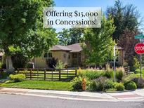 Charming single-story home with a well-manicured front yard and mature trees, offering $15,000 in concessions at 1594 S Locust St, Denver, CO 80224