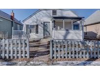 White house with gray fence and porch at 939 Knox Ct, Denver, CO 80204