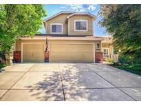 Charming two-story home with a three-car garage, well-maintained lawn, and beautiful landscaping at 16084 Stonebriar Dr, Parker, CO 80134