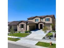 Beautiful two-story home featuring stone accents, a tile roof, a two-car garage, and a well-manicured front yard at 2125 S Orion St, Lakewood, CO 80228