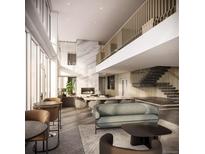 Bright, open living space featuring a modern fireplace and staircase at 525 18Th St # 1303, Denver, CO 80202