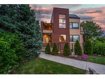 Beautiful two-story home featuring a well-manicured lawn and a brick facade at 402 Garfield St, Denver, CO 80206