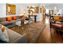 Inviting living room with hardwood floors, stylish decor, and an open floor plan to the kitchen at 402 Garfield St, Denver, CO 80206
