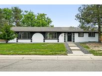 Charming single-story home with a modern design and freshly manicured lawn at 10320 W 35Th Ave, Wheat Ridge, CO 80033