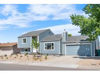 Charming two-story home featuring stylish blue siding and an attached garage at 6604 S Dahlia Cir, Centennial, CO 80121