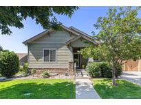 Charming single-story home with a well-manicured lawn, stone accents, and a welcoming entrance at 1153 Village Cir, Erie, CO 80516