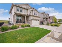 Beautiful two-story home with stone accents, a manicured lawn, and a two-car garage, offering great curb appeal at 8078 S Yantley Ct, Aurora, CO 80016