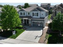Charming two-story home with well-maintained lawn and a spacious driveway with a basketball hoop at 2198 Broadleaf Loop, Castle Rock, CO 80109