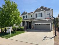 Charming two-story home featuring a well-maintained lawn, two car garage, and inviting front porch at 2198 Broadleaf Loop, Castle Rock, CO 80109