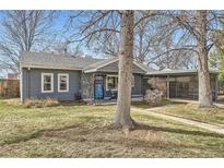Charming single-story home with gray siding, manicured lawn, mature trees, and an attached covered carport at 3041 S Fairfax St, Denver, CO 80222