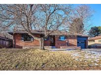 Brick ranch house with a mature tree and well-maintained landscaping at 725 S Harrison St, Denver, CO 80209