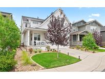 Charming two-story home featuring a beautifully landscaped yard, front porch, and inviting curb appeal at 2027 Vallejo Loop, Broomfield, CO 80023
