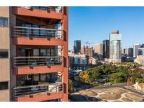 Stunning exterior view of the building featuring balconies and a beautiful city skyline backdrop at 100 Park W Ave # 1403, Denver, CO 80205