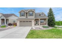 Charming two-story home with a two car garage, brick accents, and a well maintained lawn at 5625 S Buchanan St, Aurora, CO 80016