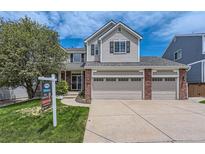 Charming two-story home featuring a three-car garage, well-manicured lawn, and inviting curb appeal at 3416 Hawthorne Dr, Highlands Ranch, CO 80126