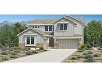Charming two-story home featuring stone accents, a two-car garage, and manicured landscaping at 428 Welded Tuff Trl, Castle Rock, CO 80104