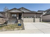 Charming single-Gathering home featuring a two-car garage, stone accents, and an inviting front porch at 15586 W Beloit Ave, Morrison, CO 80465