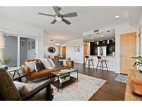 Spacious living area showcasing a modern open floor plan with kitchen, dining, and sitting areas at 1585 Hecla Way # 201, Louisville, CO 80027