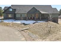 Charming two-story home with a covered porch and well-manicured front yard at 5800 Elk View Ct, Larkspur, CO 80118