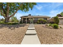 Charming ranch-style home featuring a landscaped front yard and stone walkway at 9598 Lowell Blvd, Westminster, CO 80031