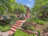 Charming brick home with a well-manicured front yard and inviting red brick stairway at 724 N Franklin St, Denver, CO 80218