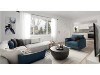 Bright living room featuring a large window, modern sectional, and stylish decor at 1225 S Xavier St, Denver, CO 80219