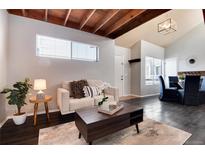 Bright living room featuring modern decor and a cozy seating area, wood ceilings, and large windows at 1830 Newland Ct # 321, Lakewood, CO 80214