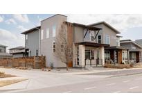 Contemporary home with a neutral color palette, stone accents, and well-maintained landscaping at 11090 E 26Th Ave, Aurora, CO 80010