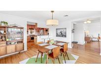 Dining area near the kitchen, featuring hardwood floors and stylish decor at 5055 W 33Rd Ave, Denver, CO 80212