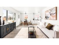 Bright living room features modern decor, hardwood floors, and plenty of natural light at 7795 Perry Pl, Westminster, CO 80030