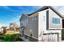Charming two-story home boasts a well-manicured lawn and attached two-car garage, perfect for suburban living at 9756 Ash Ln, Thornton, CO 80229