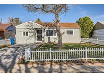 Charming single-story home featuring a well-maintained front yard with a classic white picket fence at 1364 Lansing St, Aurora, CO 80010