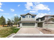 Inviting two-story home featuring a well-maintained lawn, two-car garage, and freshly painted exterior at 2231 E 128Th Ave, Thornton, CO 80241