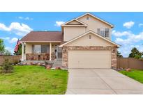 Charming two-story home featuring stone accents, a covered porch, and an attached two car garage at 4873 Eckert St, Castle Rock, CO 80104