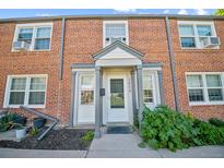Charming brick townhouse featuring front door with sidelights and a covered entryway, perfect for curb appeal at 2858 Jasmine St, Denver, CO 80207