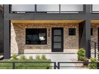 Modern brick home with black framed windows and front door that has decorative glass panels at 425 S Pearl St, Denver, CO 80209