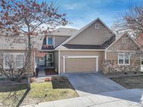 Charming two-story home featuring a two-car garage, stone accents, and a well-maintained front yard at 6068 W Utah Ln, Lakewood, CO 80232