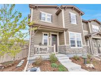 Charming two-story home with stone accents, covered porch, and well-maintained landscaping at 3778 Happyheart Way, Castle Rock, CO 80109