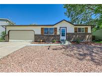 Charming single-story home with brick accents, well-maintained landscaping, and a two-car garage at 6010 S Garland Way, Littleton, CO 80123