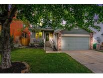 Charming home featuring a well-kept lawn, inviting porch, and two-car garage, perfect for suburban living at 12261 N Holly Way, Brighton, CO 80602
