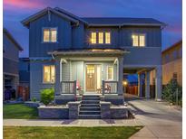 Charming two-story home featuring a covered front porch, well-manicured lawn, and convenient attached carport at 8444 E 55Th Pl, Denver, CO 80238