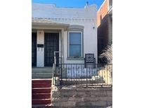 White brick home with a small front porch and wrought iron fence at 3327 Navajo St, Denver, CO 80211