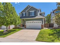 Charming two-story home features a large front yard and a spacious two-car garage at 10460 Ketchwood Ct, Highlands Ranch, CO 80130
