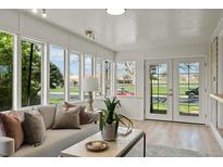 Bright sunroom with lots of natural light and view of the outdoors at 2276 Newland St, Edgewater, CO 80214