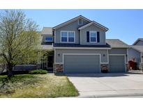 Charming two-story home with a three-car garage, well-manicured lawn, and mature trees at 952 Eaglestone Dr, Castle Rock, CO 80104
