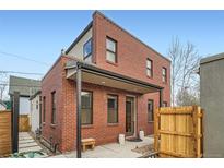 Charming two-story brick home featuring a covered entryway and well-maintained landscaping at 3643 Zuni St, Denver, CO 80211