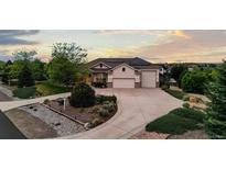 Stunning home with three-car garage, mature trees, solar panels and beautiful landscaping at 8211 E 128Th Pl, Thornton, CO 80602