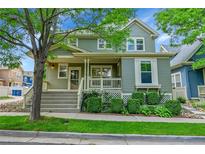 Charming two-story home with landscaped front yard and inviting covered porch at 9270 107Th E Pl, Commerce City, CO 80640